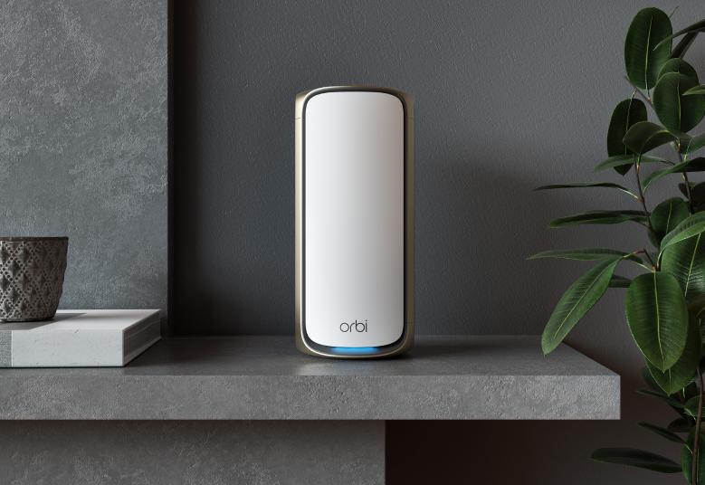 An image showing the BE27000 Mesh WiFi System (RBE973S) installed within a home environment, seamlessly integrating into the living space while providing high-speed internet connectivity. The Orbi 970 Series Quad-Band WiFi 7 Mesh System ensures comprehensive coverage and reliable performance for modern households.